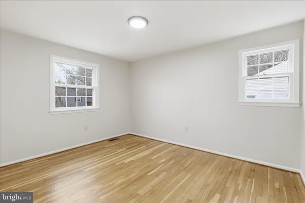 a view of an empty room and wooden floor