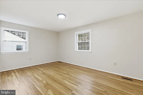 a view of an empty room and wooden floor