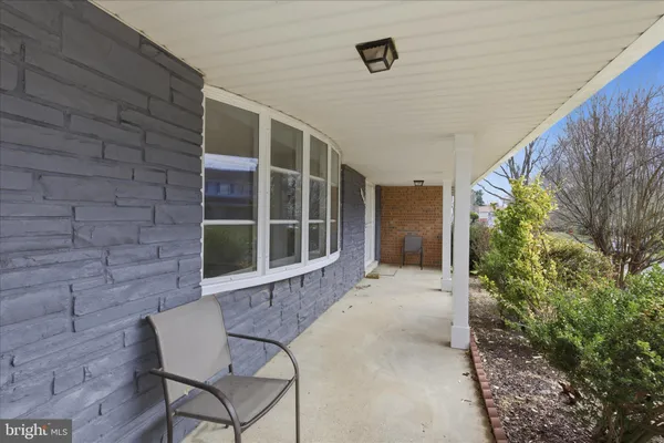a view of house with backyard and glass windows