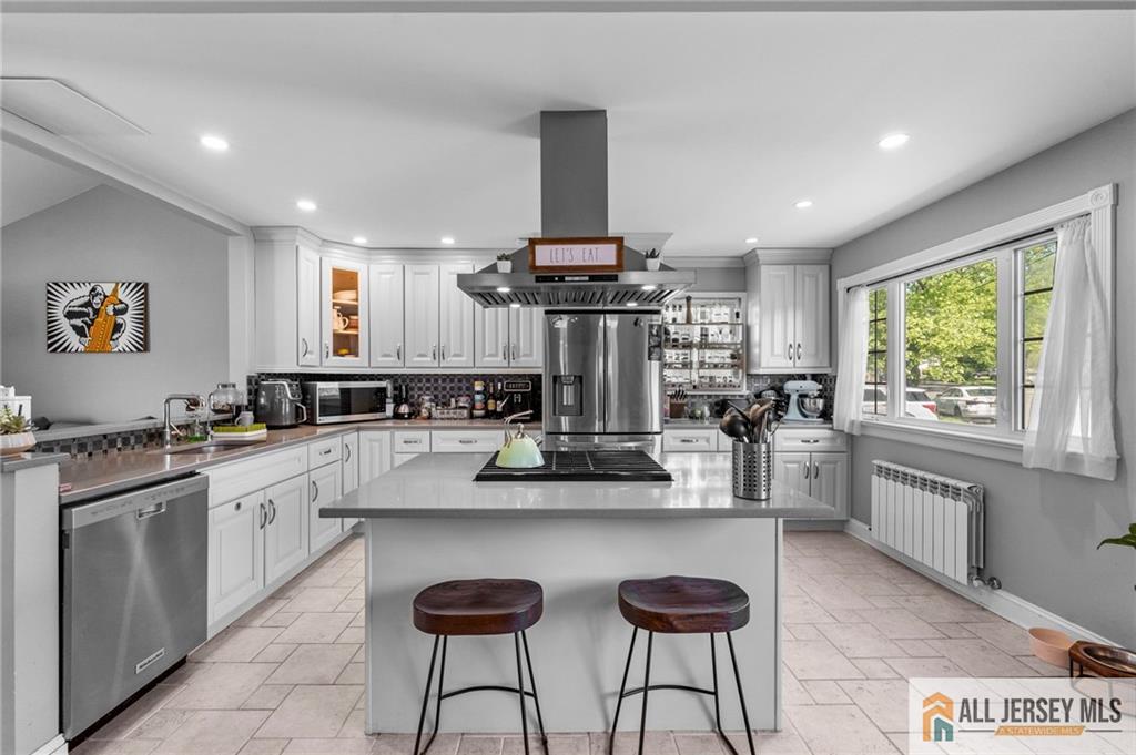 21 Starlight Drive Colonia, NJ 07067 - Photo 13 of 41 a kitchen with stainless steel appliances kitchen island granite countertop a stove a sink and a refrigerator