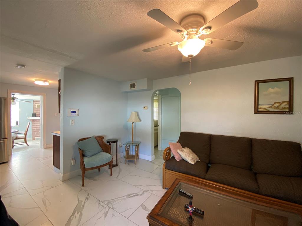 910 Lake Avenue Edgewater, FL 32132 - Photo 5 of 23 a living room with furniture and a chandelier