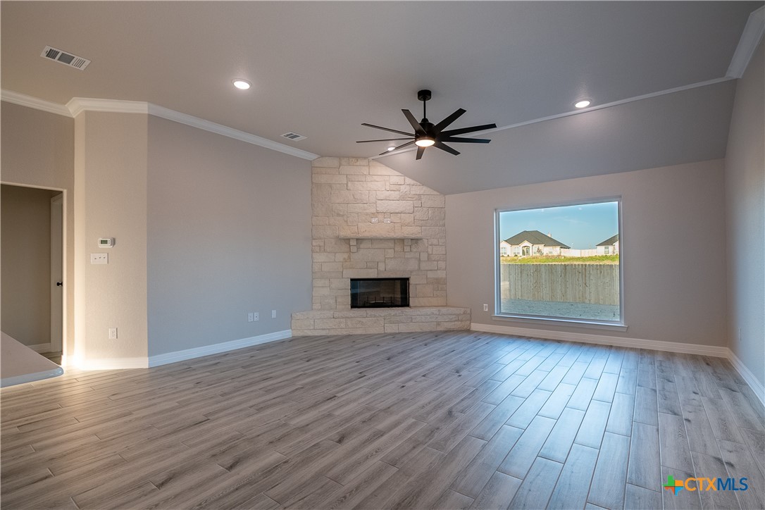 1404 Red Rock Road Hewitt, TX 76643 - Photo 13 of 30 a view of an empty room with a fireplace and a window