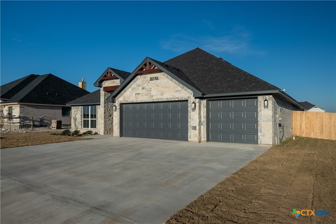 1404 Red Rock Road Hewitt, TX 76643 - Photo 2 of 30 a front view of a house with a yard and garage