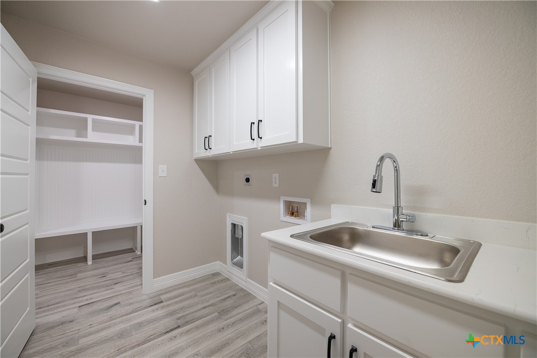 1404 Red Rock Road Hewitt, TX 76643 - Photo 21 of 30 a view of a kitchen sink and cabinets