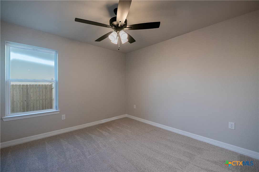 1404 Red Rock Road Hewitt, TX 76643 - Photo 22 of 30 an empty room with a window and a fan