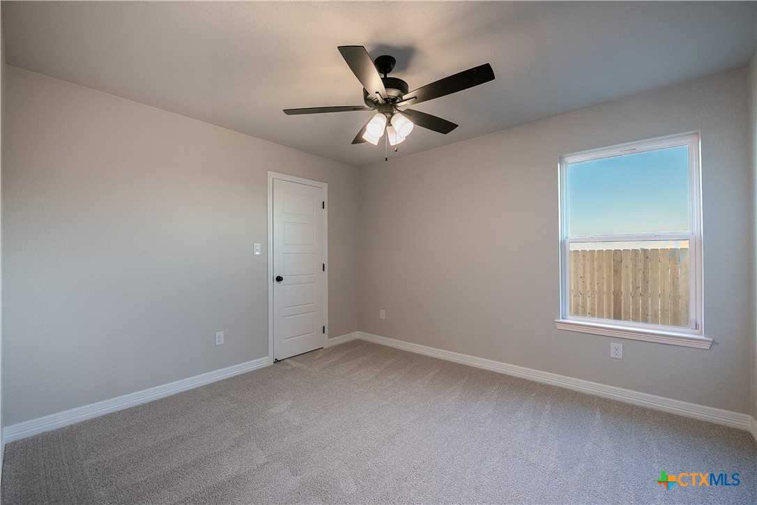 1404 Red Rock Road Hewitt, TX 76643 - Photo 24 of 30 an empty room with a window and a fan