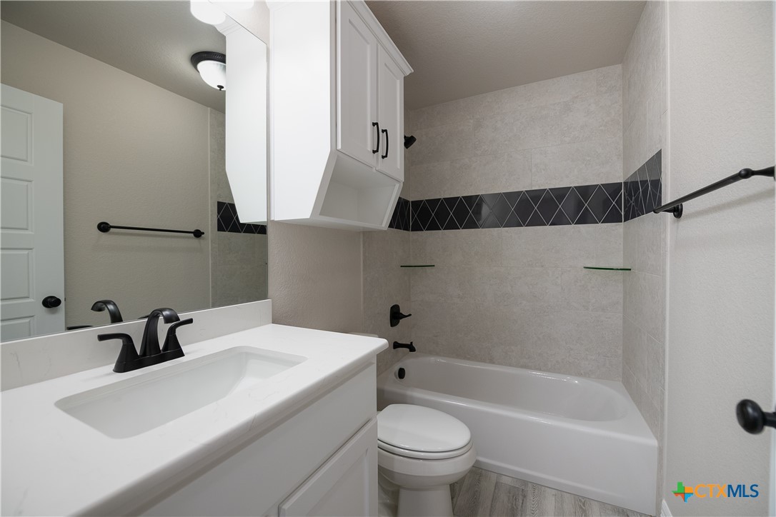 1404 Red Rock Road Hewitt, TX 76643 - Photo 26 of 30 a bathroom with a sink a toilet and shower