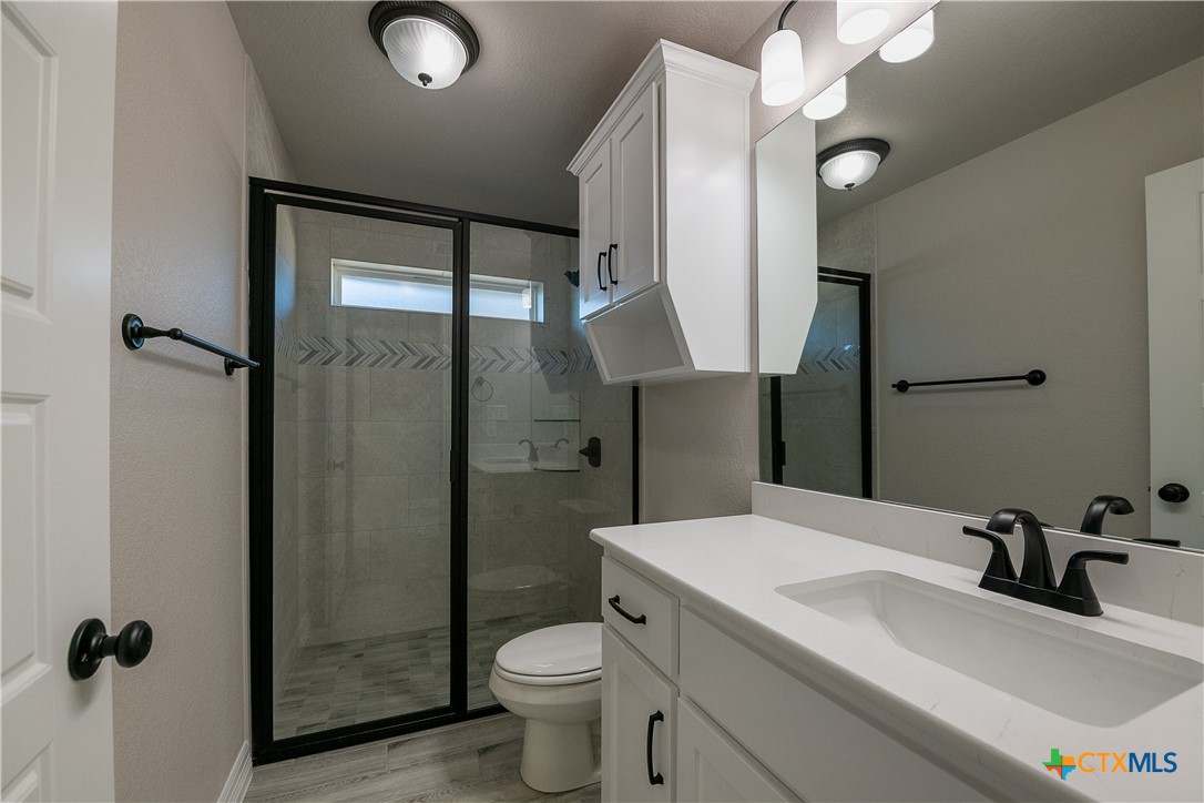 1404 Red Rock Road Hewitt, TX 76643 - Photo 6 of 30 a bathroom with a sink toilet and shower
