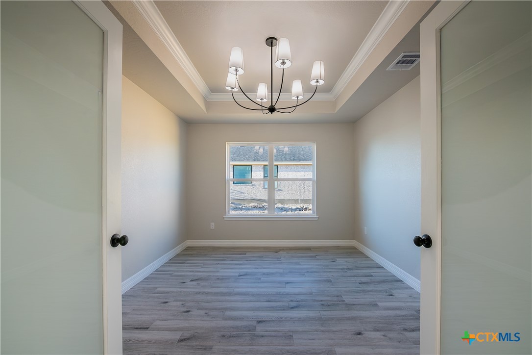 1404 Red Rock Road Hewitt, TX 76643 - Photo 8 of 30 a view of an empty room with wooden floor