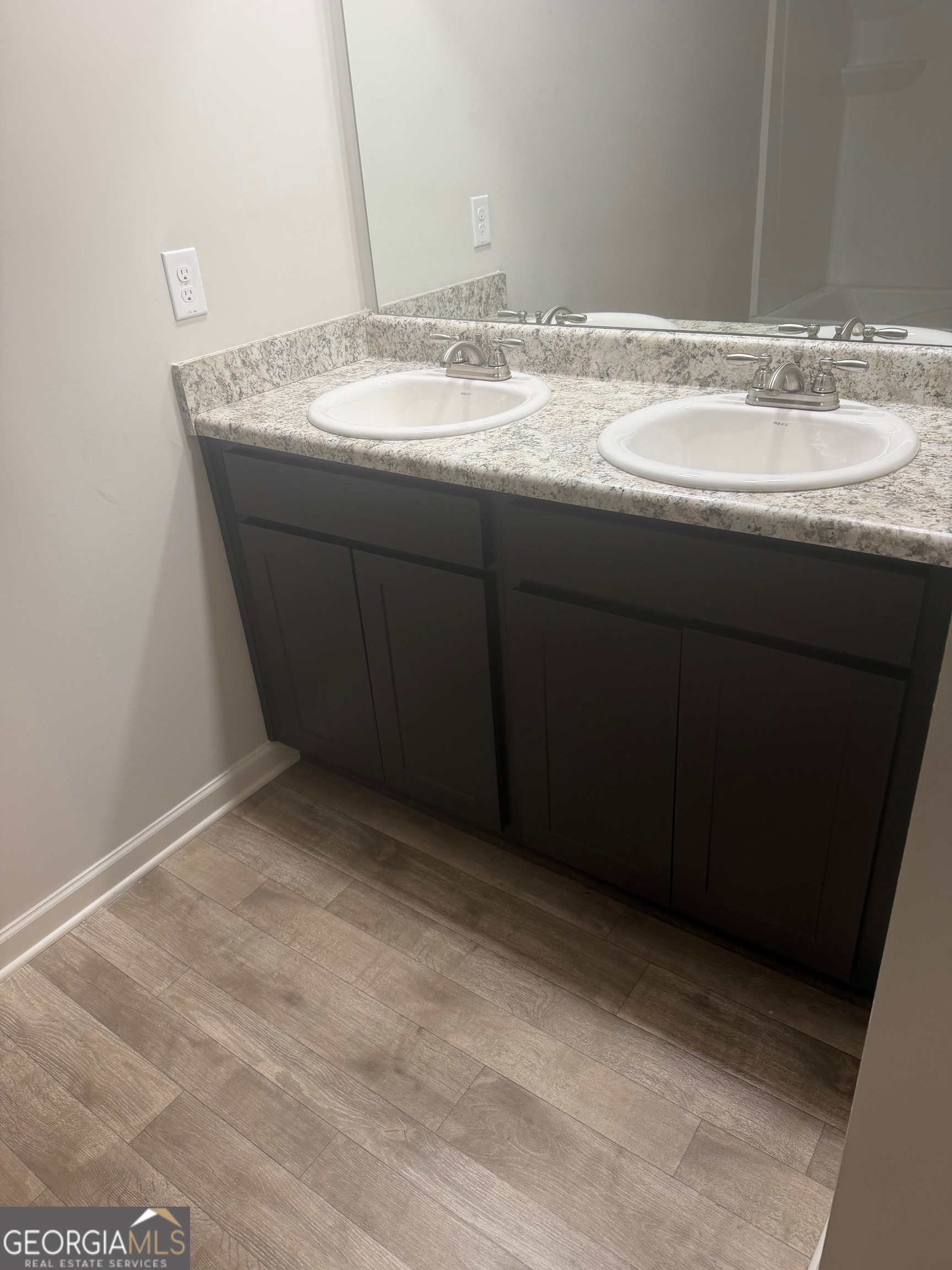 399 Toronto Circle, Unit 281 Hampton, GA 30228 - Photo 11 of 18 a bathroom with a granite countertop sink and a mirror