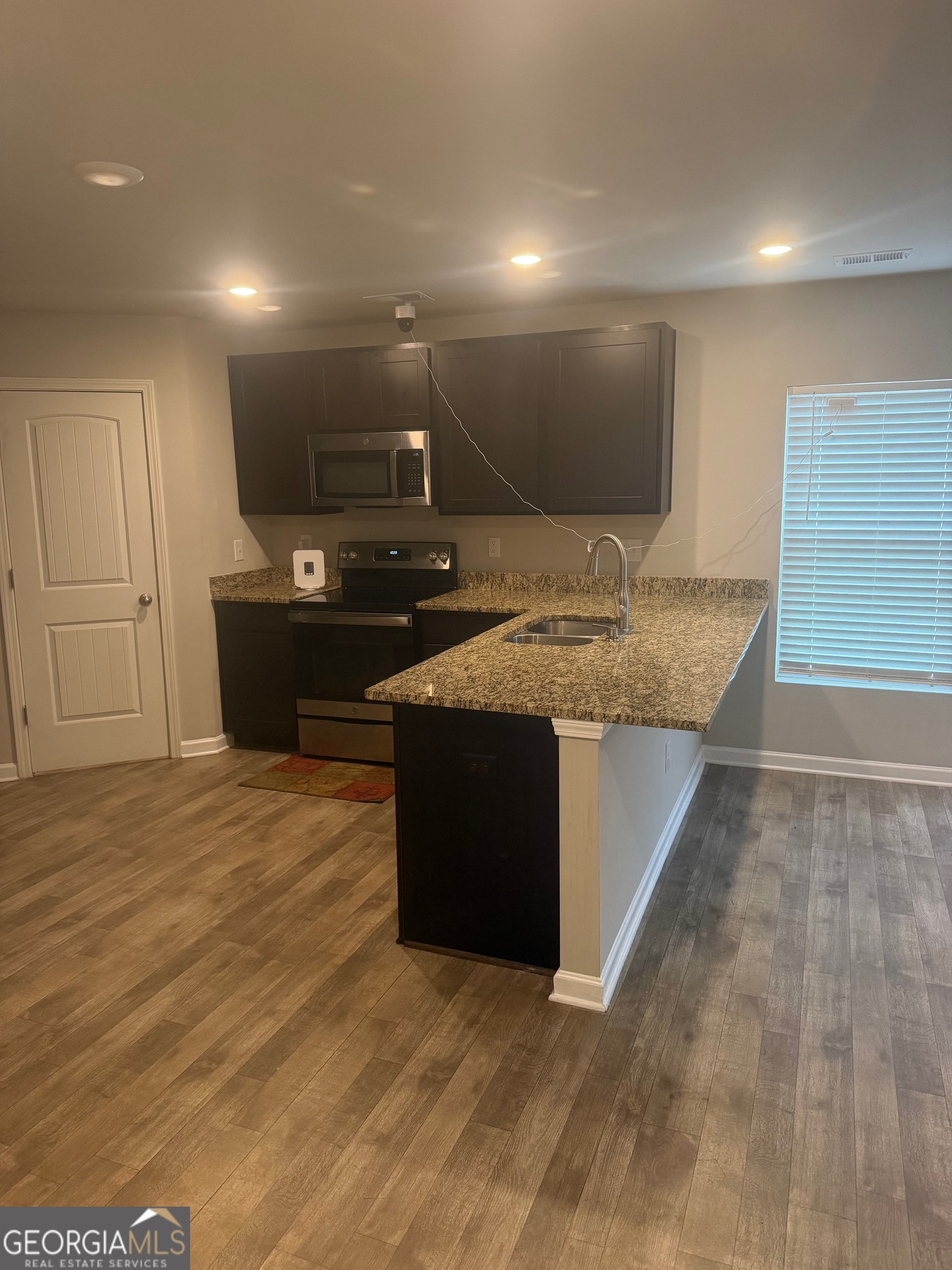399 Toronto Circle, Unit 281 Hampton, GA 30228 - Photo 3 of 18 a kitchen with a sink and a stove top oven