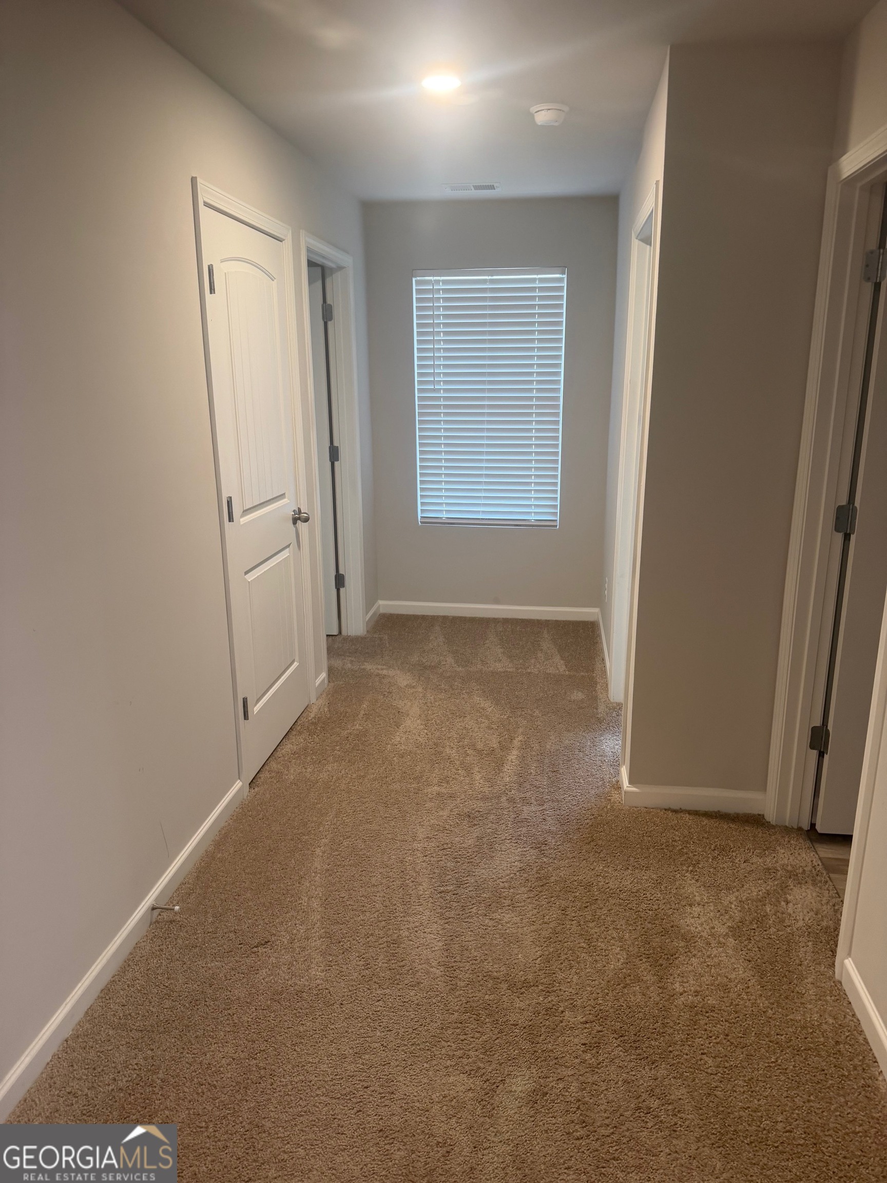 399 Toronto Circle, Unit 281 Hampton, GA 30228 - Photo 7 of 18 an empty room with windows and closet