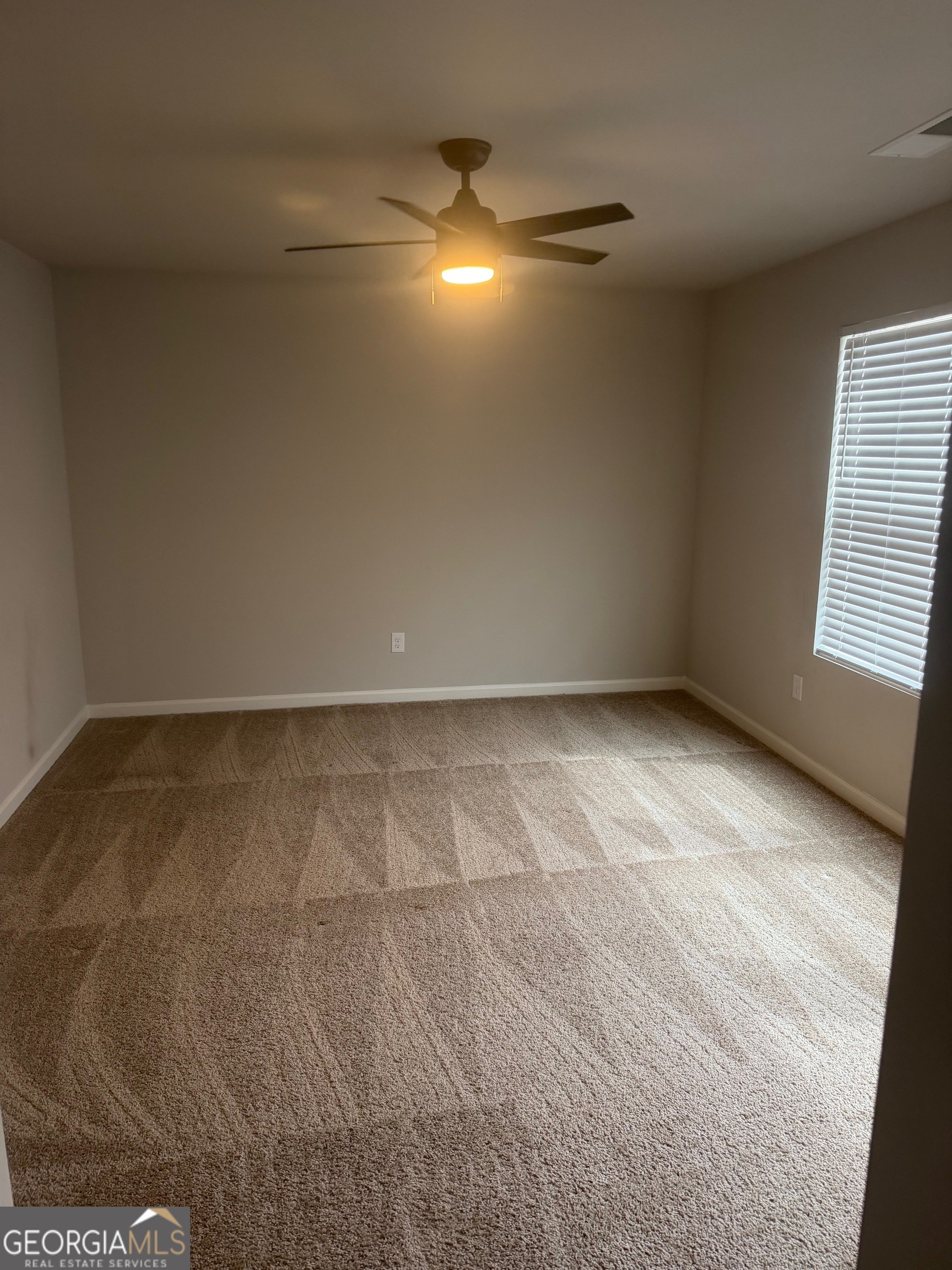 399 Toronto Circle, Unit 281 Hampton, GA 30228 - Photo 9 of 18 a view of an empty room and window