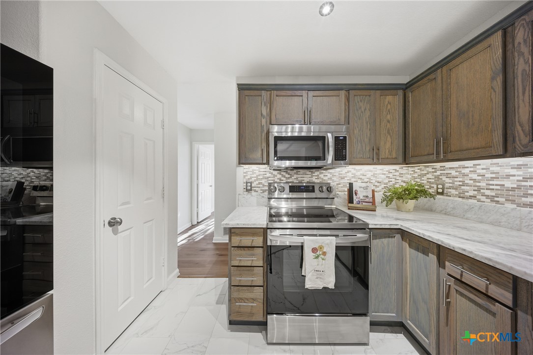658 Devin Drive Temple, TX 76502 - Photo 11 of 30 a kitchen with a stove and a sink