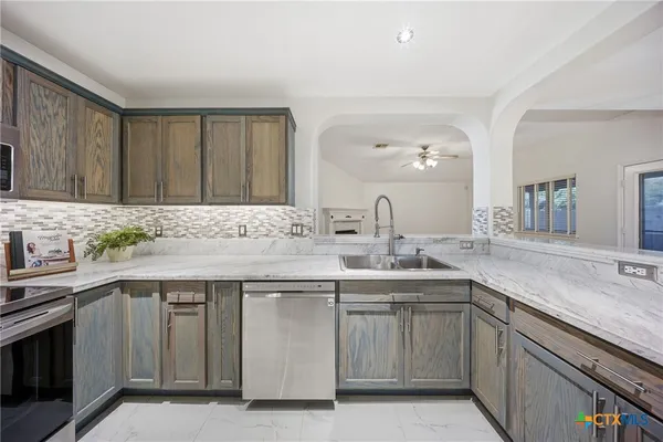 a kitchen with a sink stove and cabinets