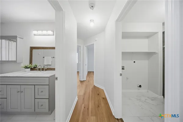 a spacious bathroom with a granite countertop sink