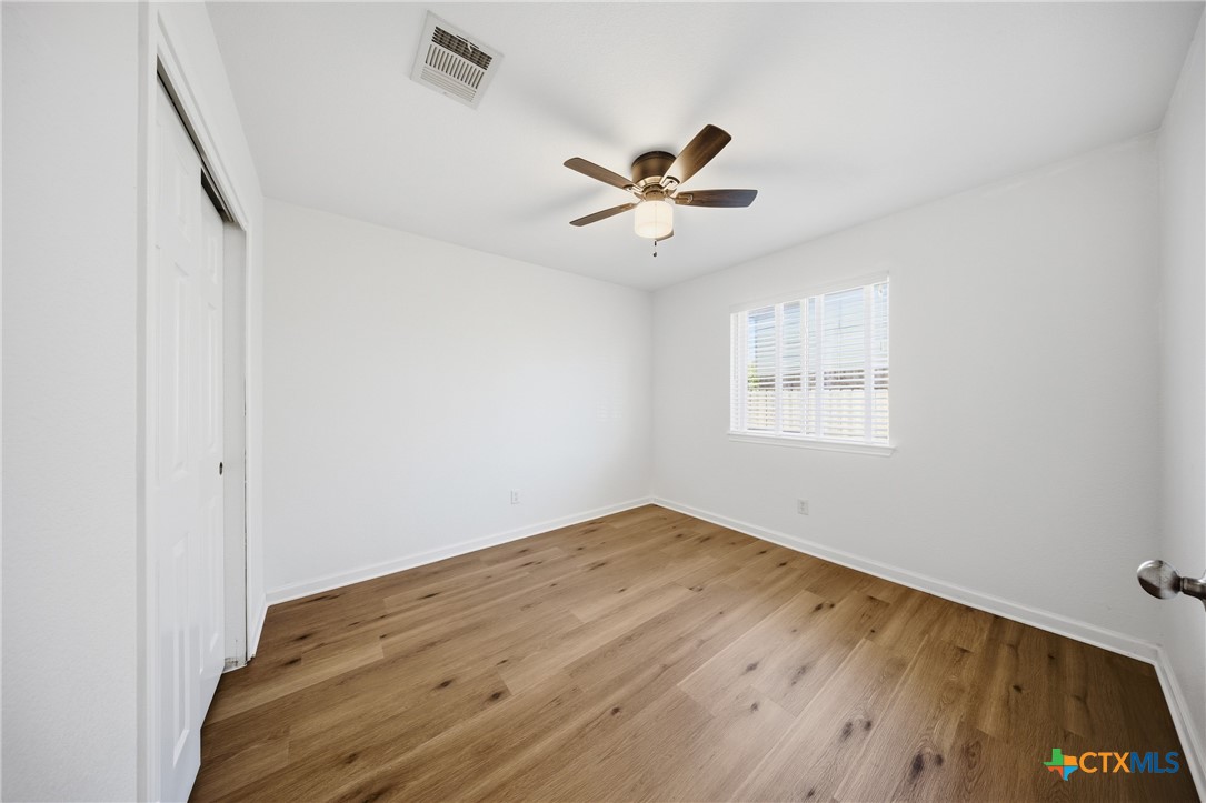 658 Devin Drive Temple, TX 76502 - Photo 25 of 30 a view of empty room with wooden floor and fan