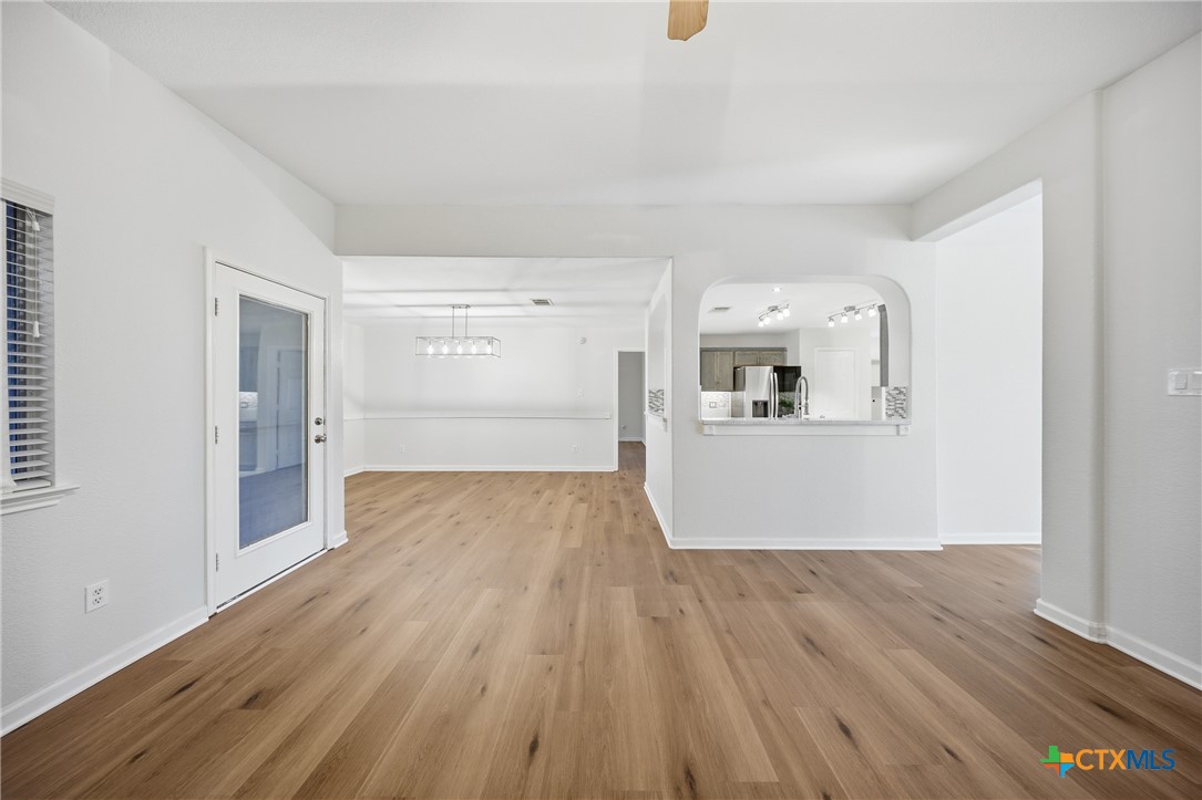658 Devin Drive Temple, TX 76502 - Photo 7 of 30 a view of a kitchen with wooden floor and a refrigerator