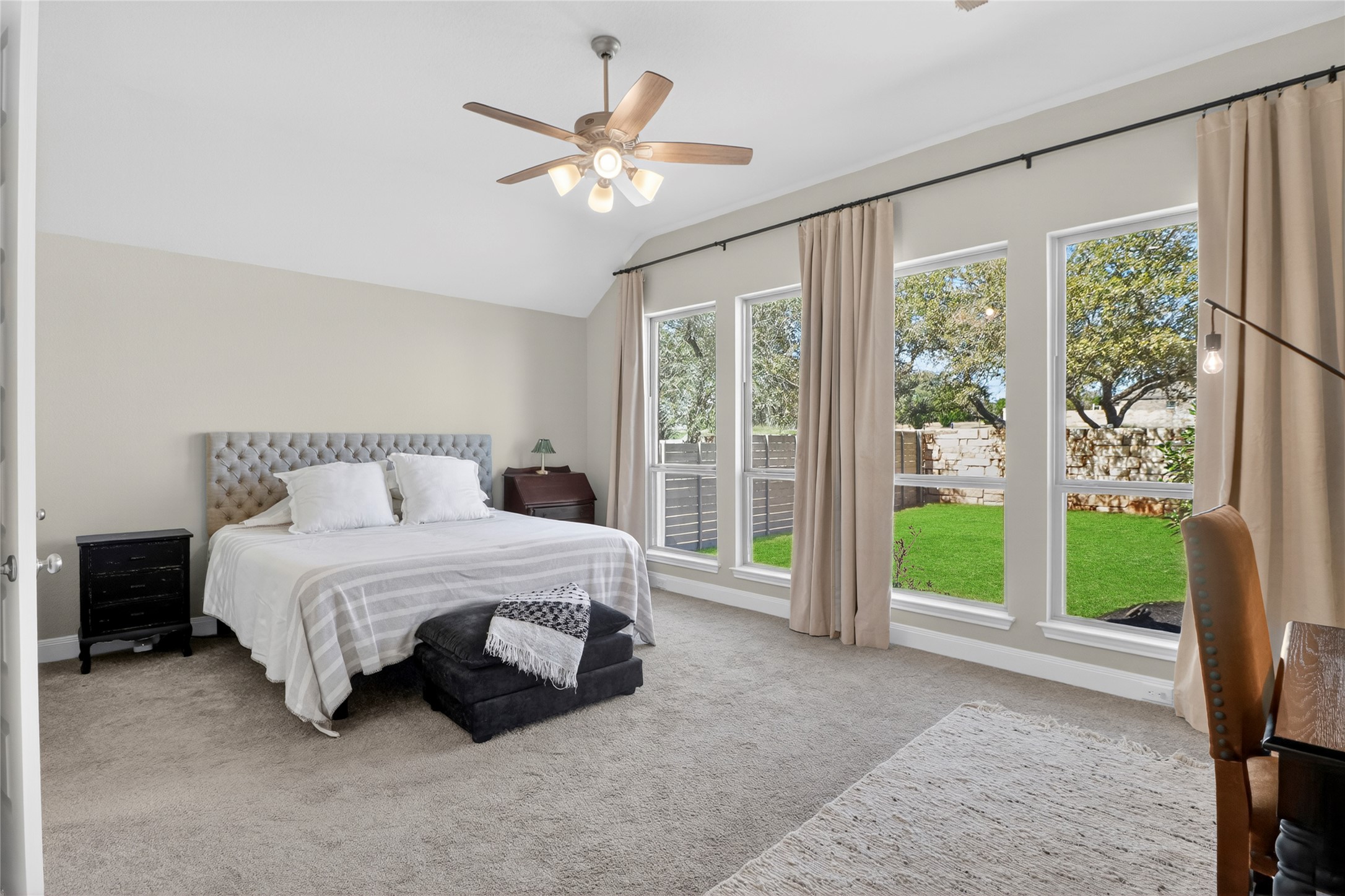 100 Peach Orch Lane Georgetown, TX 78628 - Photo 12 of 40 a spacious bedroom with a large bed and a chandelier