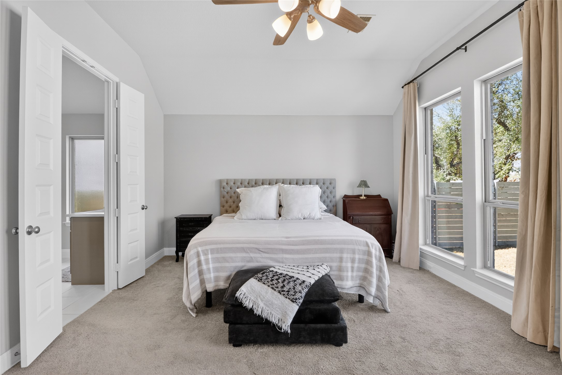 100 Peach Orch Lane Georgetown, TX 78628 - Photo 13 of 40 a bedroom with a bed and a chandelier