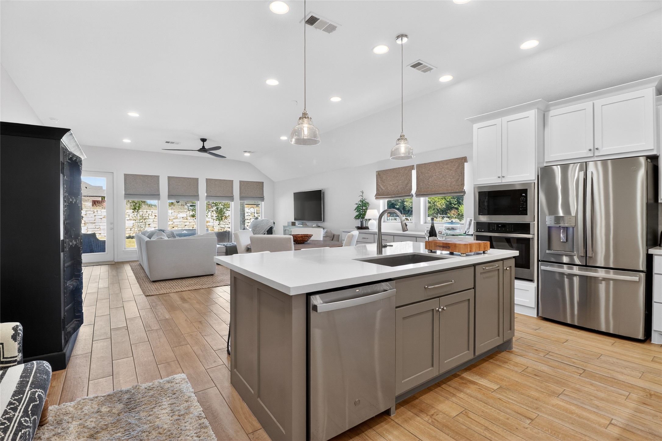 100 Peach Orch Lane Georgetown, TX 78628 - Photo 2 of 40 a kitchen with kitchen island a counter top space a sink stainless steel appliances and cabinets