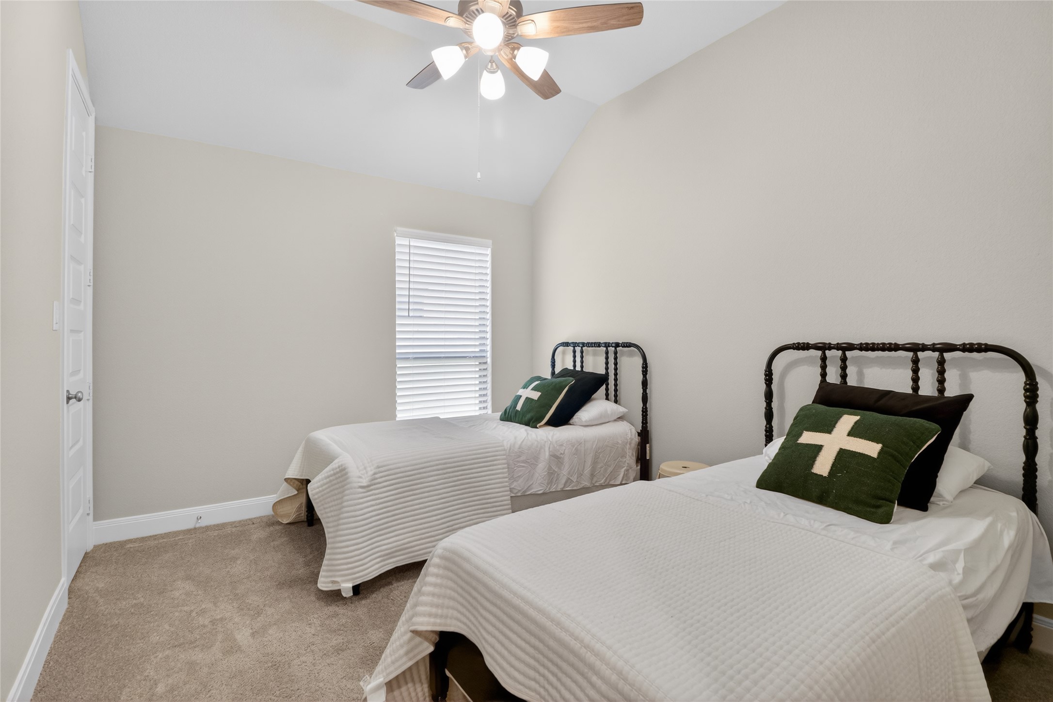 100 Peach Orch Lane Georgetown, TX 78628 - Photo 24 of 40 a bedroom with two beds and a chandelier