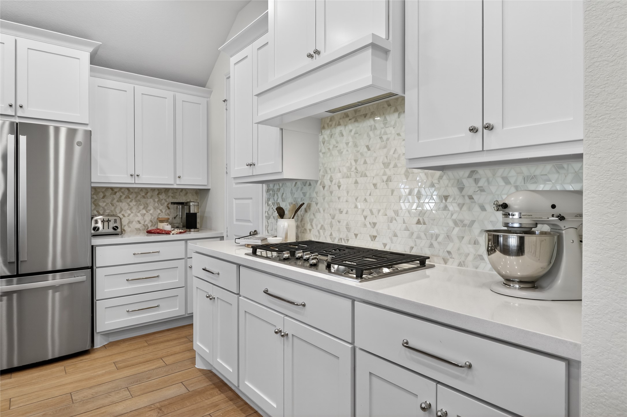 100 Peach Orch Lane Georgetown, TX 78628 - Photo 4 of 40 a kitchen with white cabinets and appliances