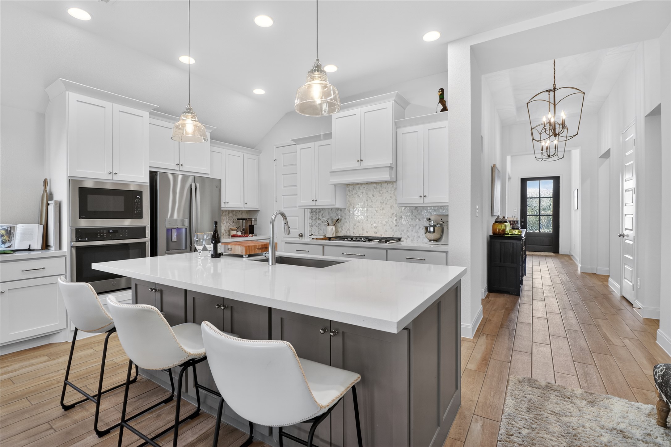 100 Peach Orch Lane Georgetown, TX 78628 - Photo 5 of 40 a kitchen with stainless steel appliances a table chairs refrigerator and microwave