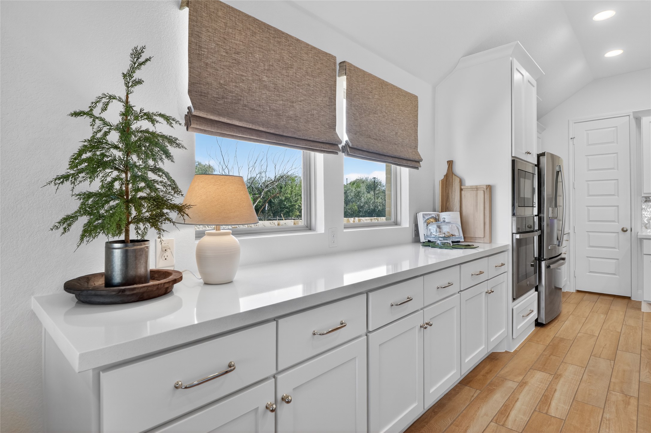 100 Peach Orch Lane Georgetown, TX 78628 - Photo 7 of 40 a kitchen with cabinets a potted plant a sink and a window