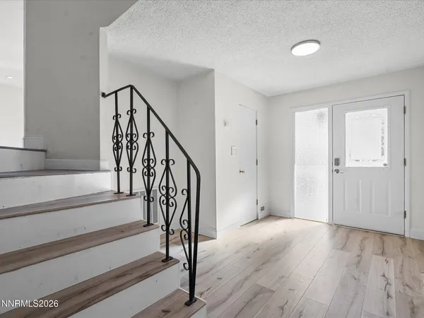 a view of an entryway with wooden floor and door