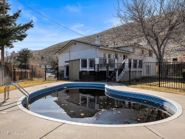 a view of a house with swimming pool and sitting area