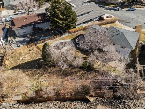 an aerial view of residential house with outdoor space and parking