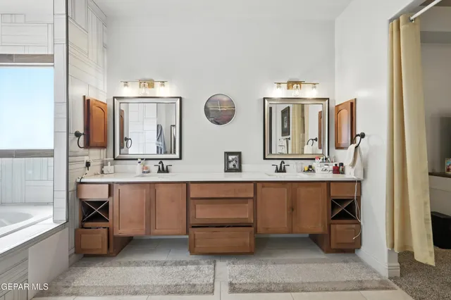 a bathroom with a double vanity sink and a mirror