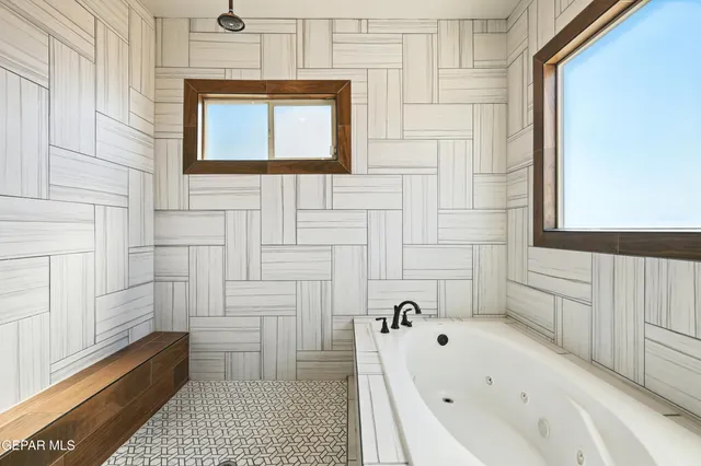 a bathroom with a bathtub and a shower