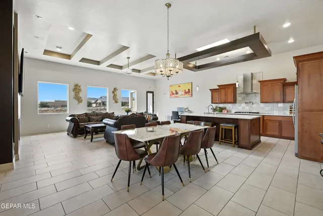 a view of kitchen with cabinets table and chairs