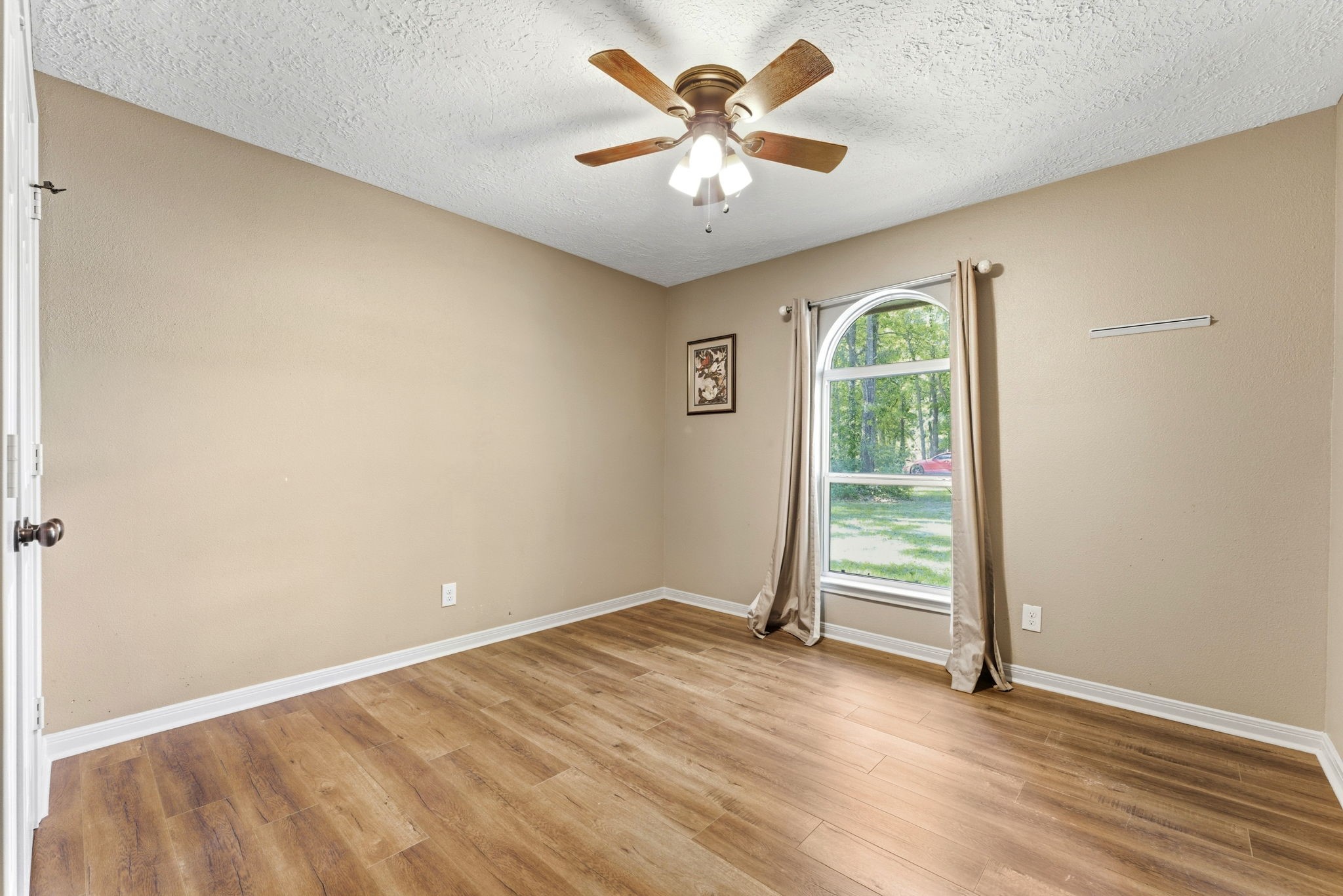 2354 Hickory Hollow Lane Spring, TX 77386 - Photo 6 of 11 an empty room with windows and fan
