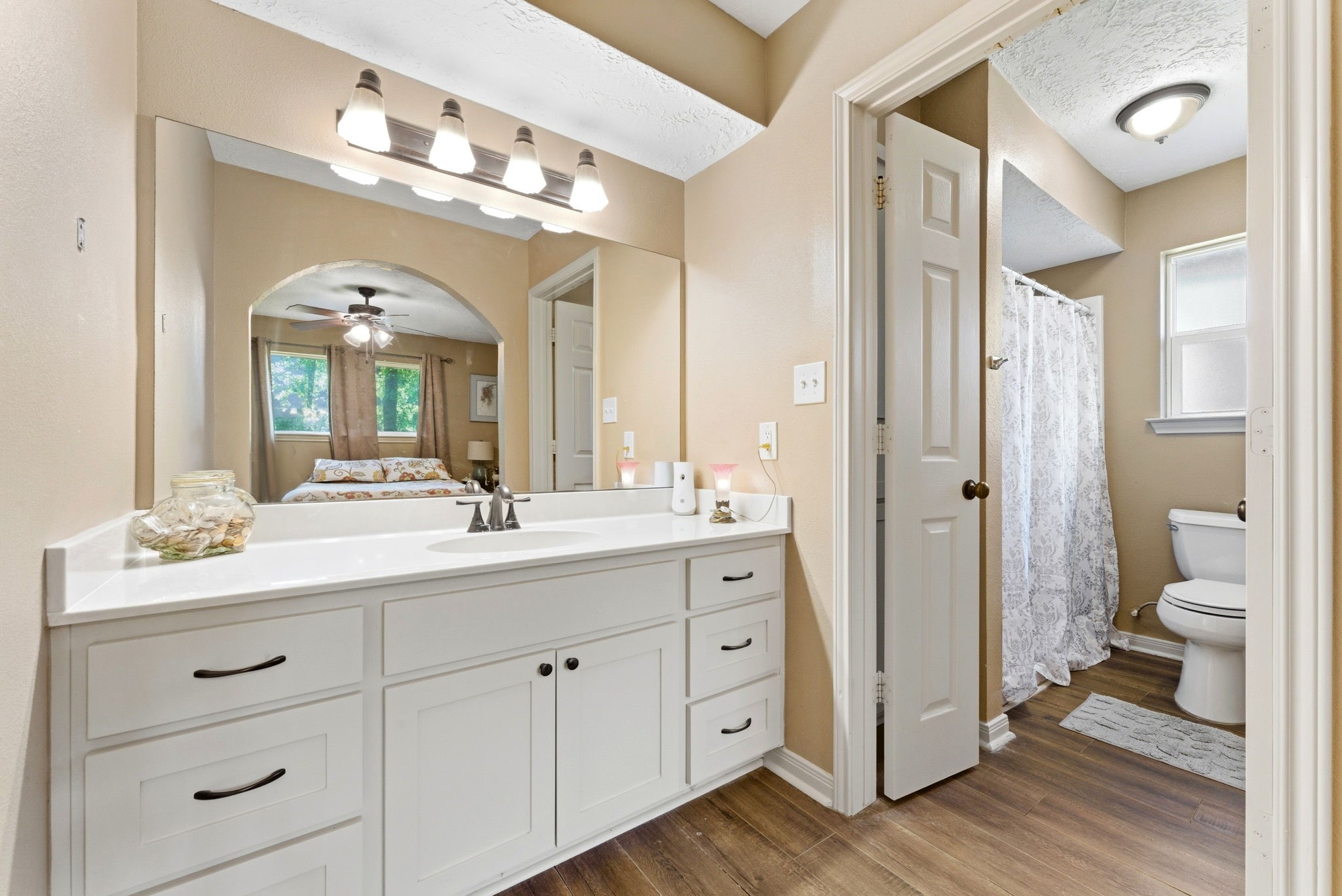 2354 Hickory Hollow Lane Spring, TX 77386 - Photo 9 of 11 a en suite bathroom with a double vanity sink a toilet and a large mirror