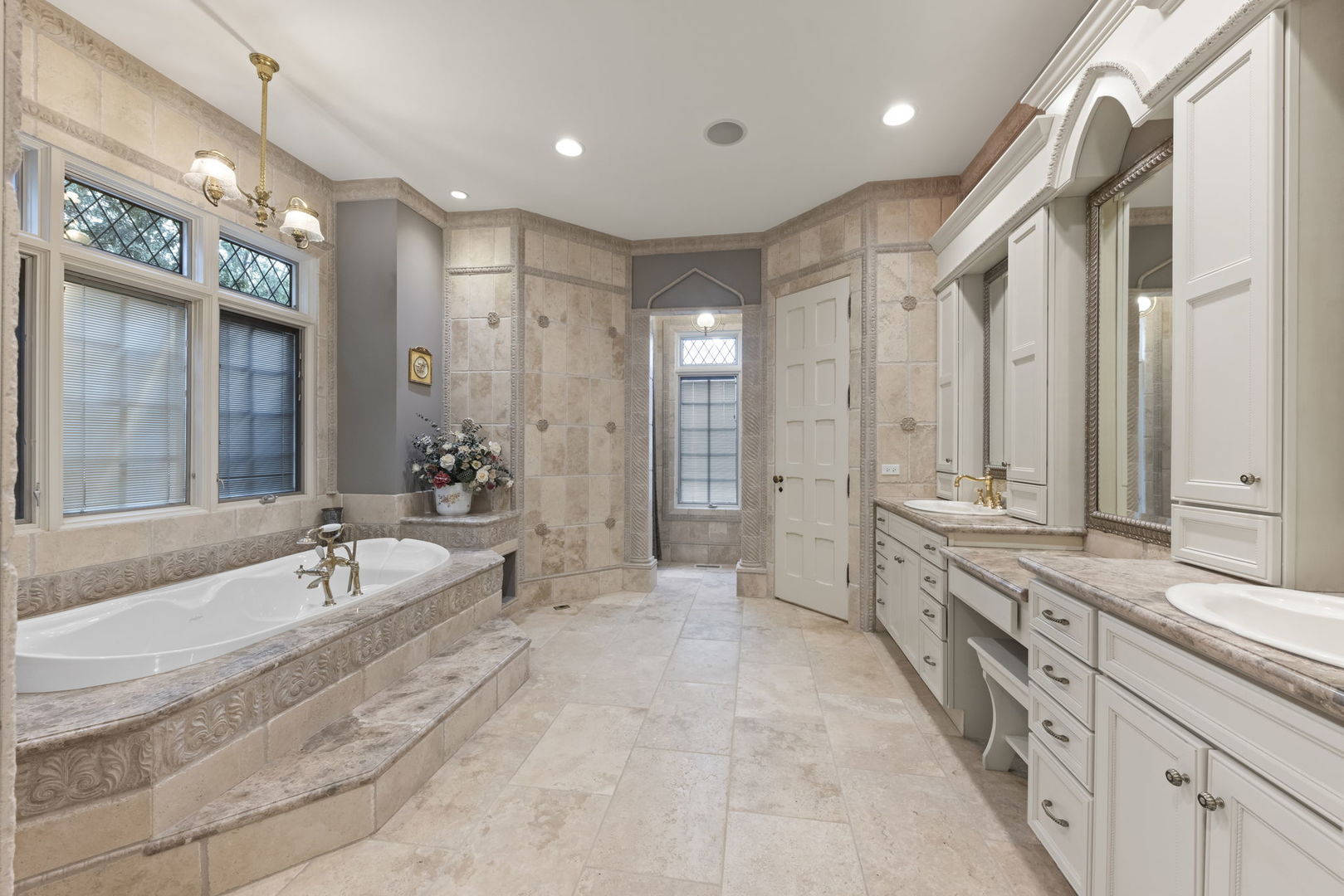24W141 Hobson Road Naperville, IL 60540 - Photo 40 of 70 a spacious bathroom with a tub sink shower and mirror