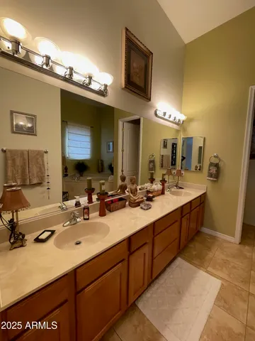 a bathroom with a double vanity sink and a mirror
