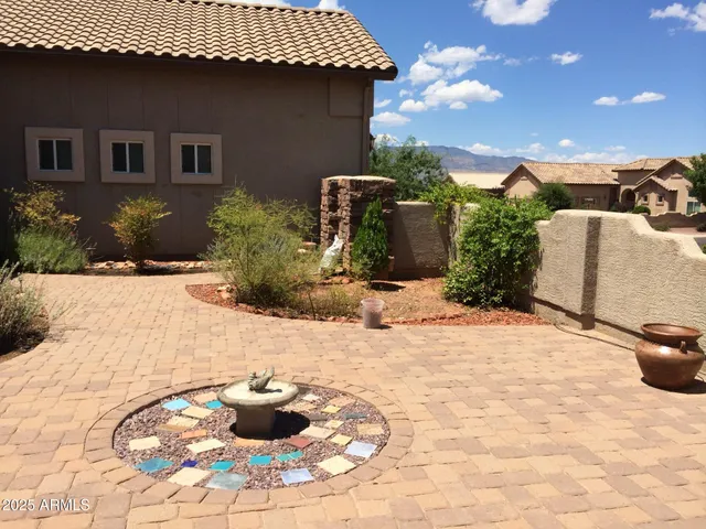 a view of a backyard of the house with potted plants