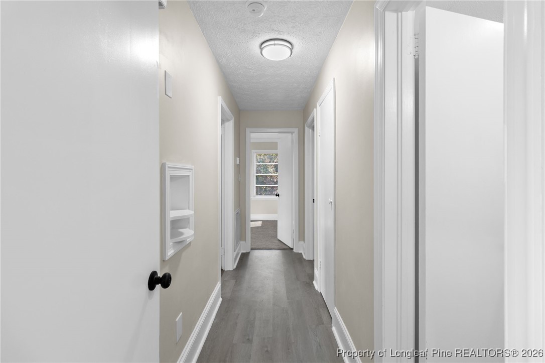 2712 Morganton Road Fayetteville, NC 28303 - Photo 17 of 39 a view of a hallway with wooden floor