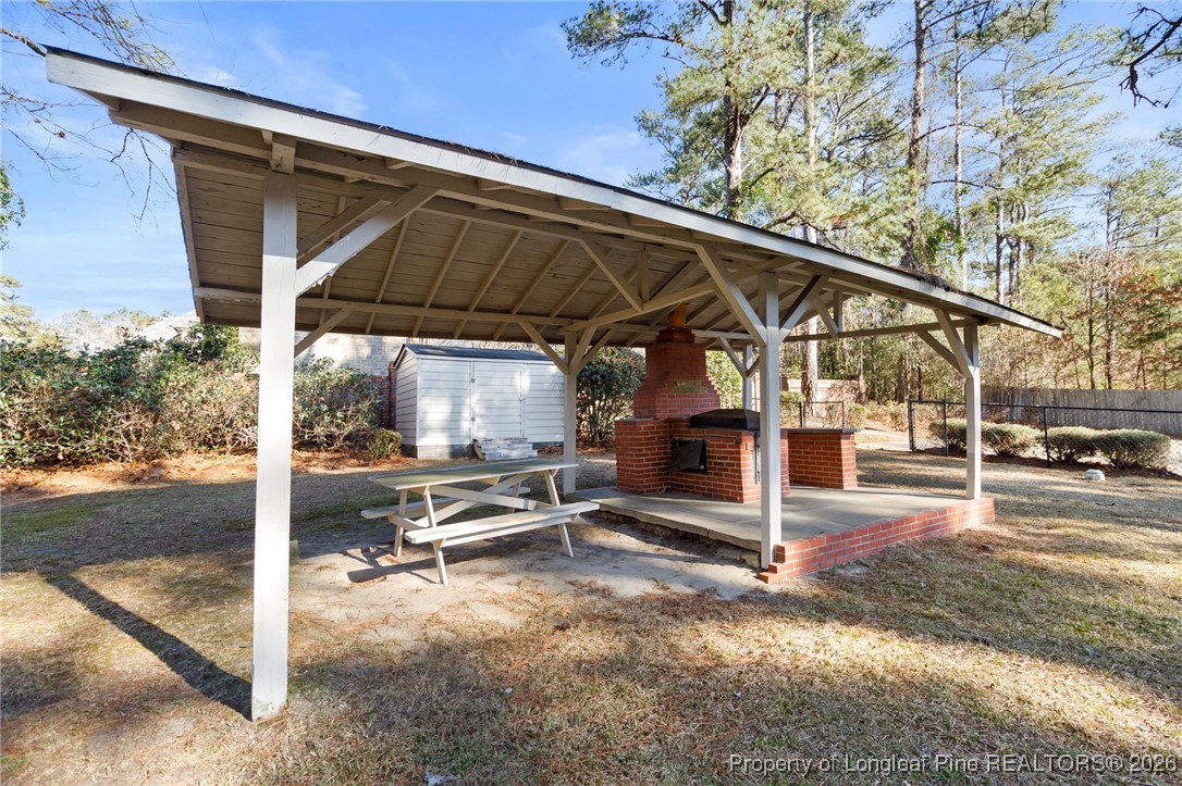 2712 Morganton Road Fayetteville, NC 28303 - Photo 35 of 39 a view of a patio with table and chairs under an umbrella
