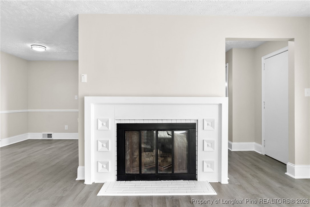2712 Morganton Road Fayetteville, NC 28303 - Photo 5 of 39 a living room with a fireplace