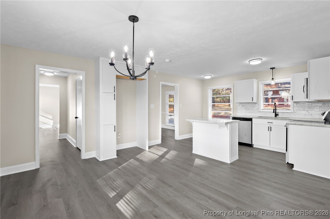 2712 Morganton Road Fayetteville, NC 28303 - Photo 8 of 39 a open kitchen with white cabinets and stainless steel appliances