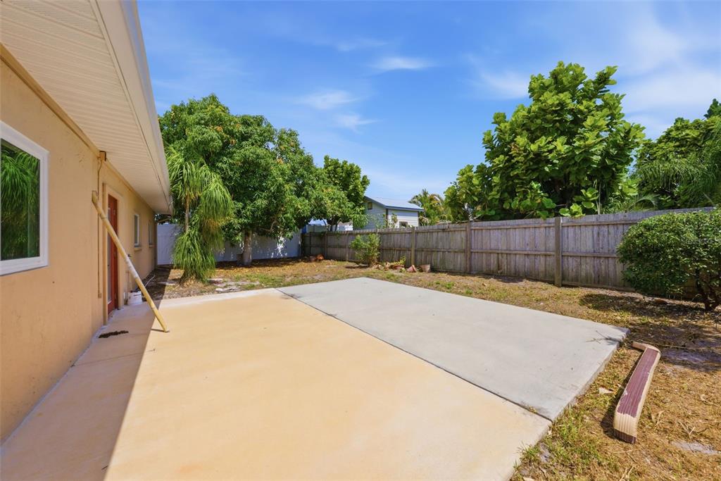 4536 Webber Street Sarasota, FL 34232 - Photo 26 of 45 a view of a backyard with plants and tree