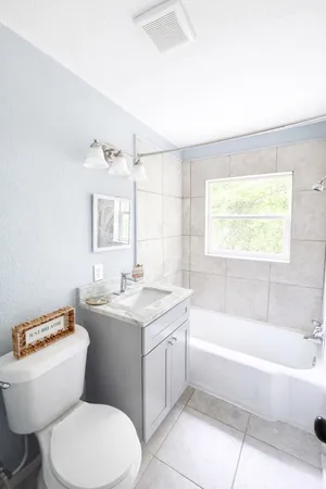 a bathroom with a toilet a sink and bathtub