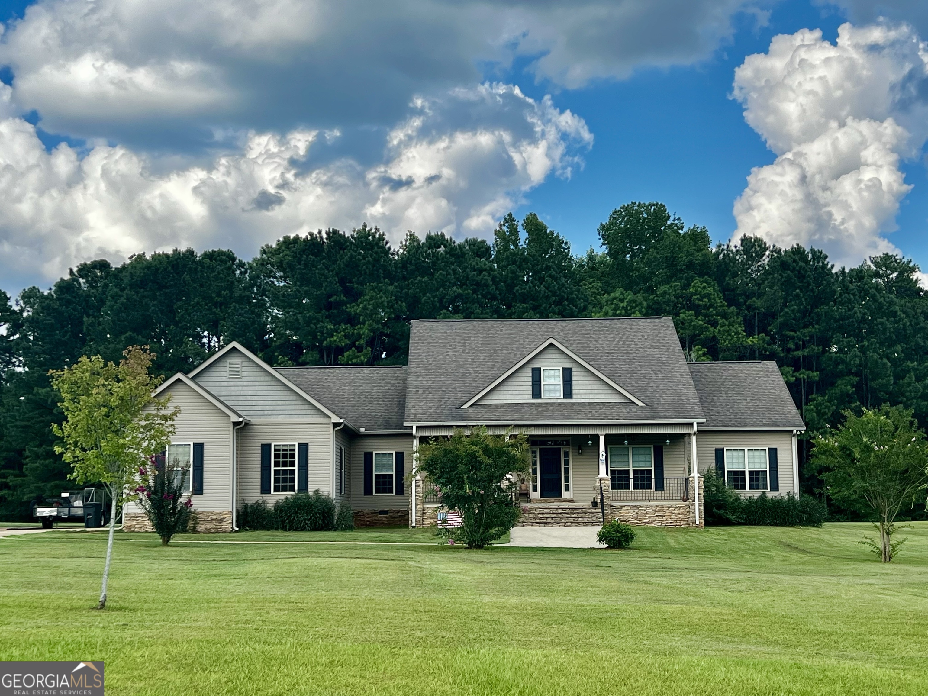a front view of a house with a garden
