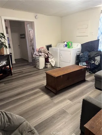 a bedroom with furniture and a wooden floor