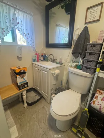 a bathroom with a toilet a sink and a mirror