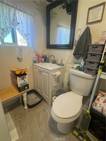 a bathroom with a toilet a sink and a mirror